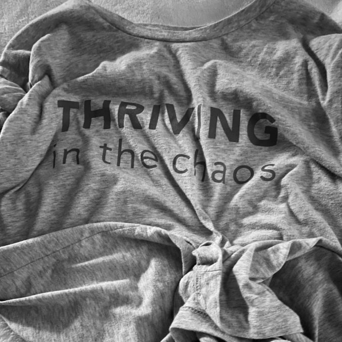 Wrinkled T-shirt with the words Thriving in the chaos